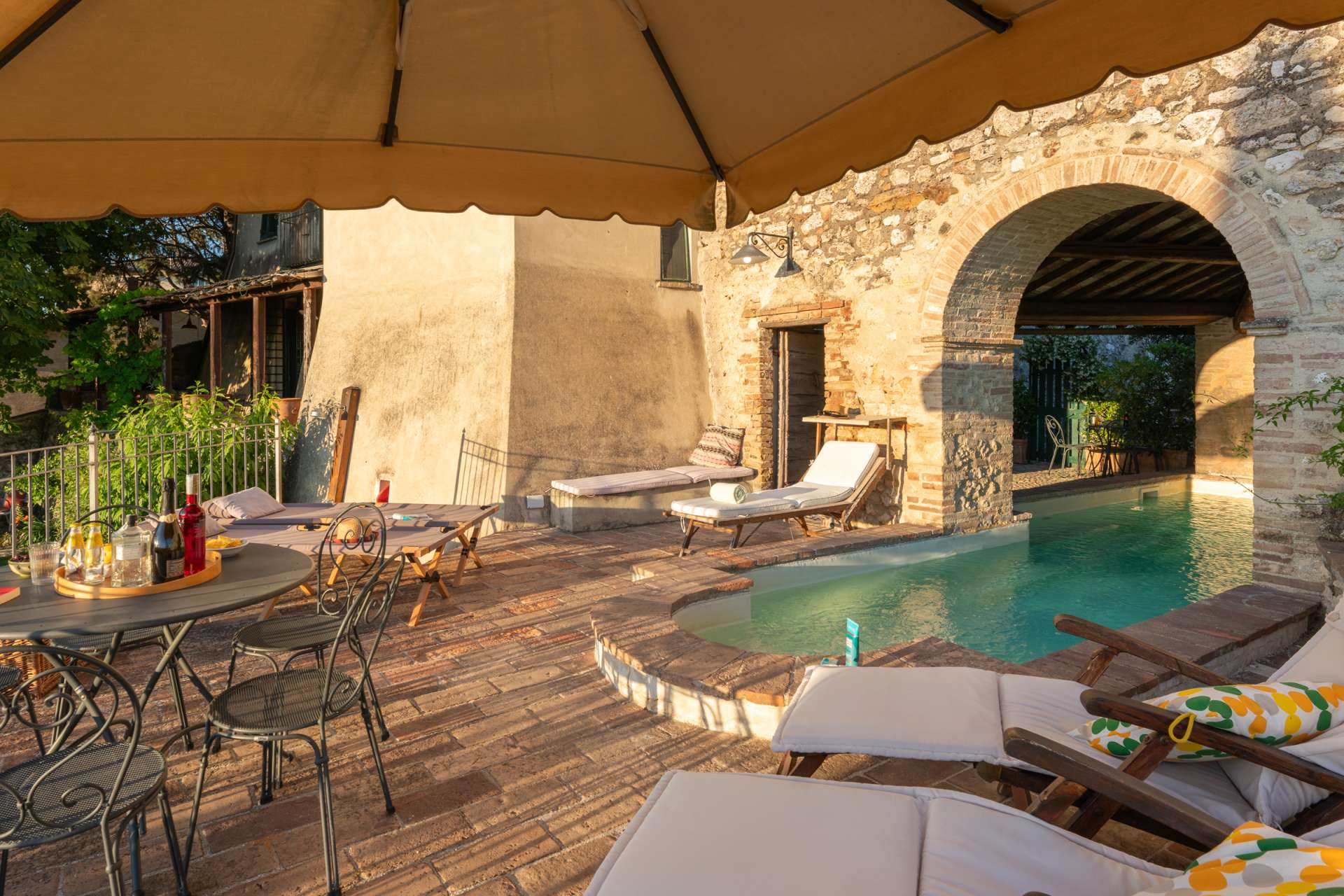Santi Terzi Nicely landscaped west-facing garden with several sitting areas below the terrace