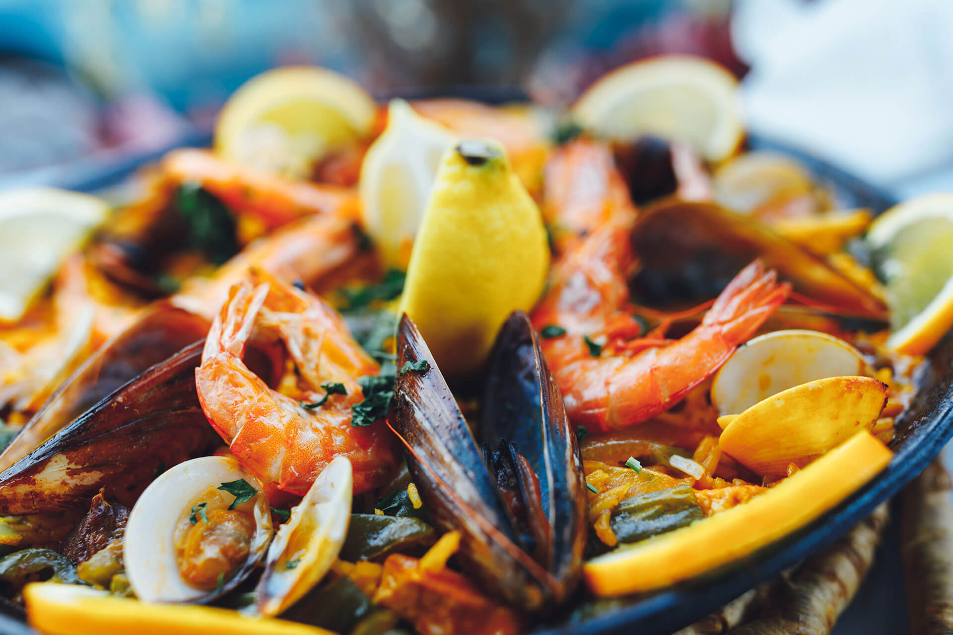 Seafood paella with prawns, mussels and lemon served in Tuscany