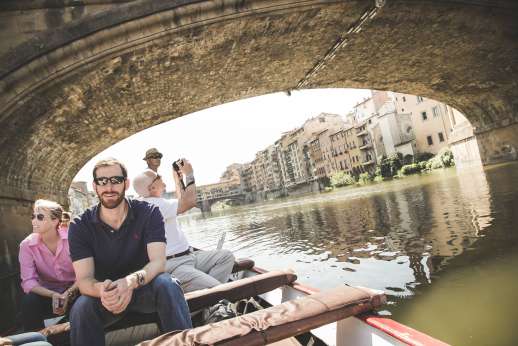 Arno Gondola Ride - A group of tourists enjoy a gondola tour along the Arno.
