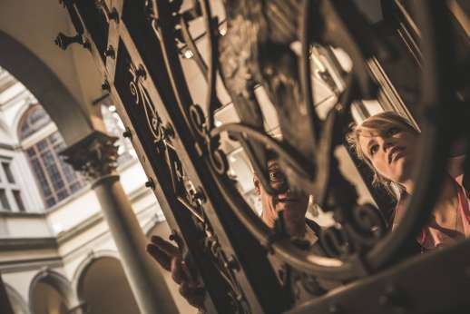 Arno Gondola Ride - A man and a woman inspect the ironwork on an old gate