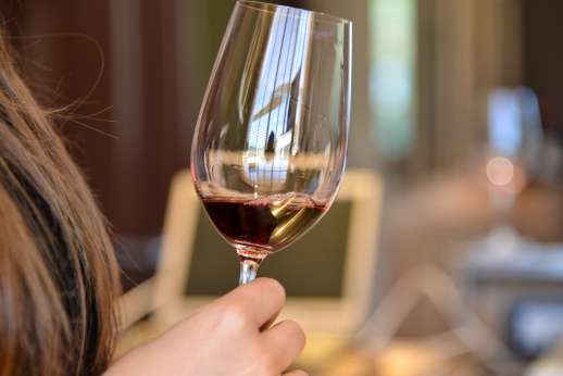 Chianti Wine Tour - A glass of red wine is swirled by a lady on the tour.