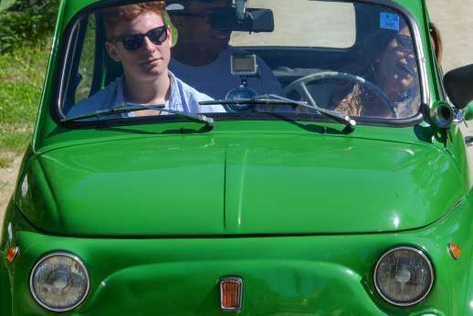 Fiat 500 Tour - Two people and a tour guide enjoy the sun in a green, classic Fiat 500.