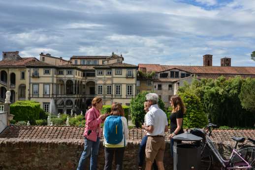 Lucca By Bike Or Foot - A tour group park their bicycles and enjoy the view of Lucca from a high vantage point.