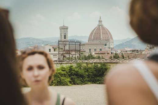 Pitti Palace & Boboli - Tourists in the foreground observe a dome and tower around Pitti Palace