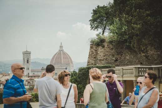 Pitti Palace & Boboli - Tourists stop to admire the view of an historic dome and tower.