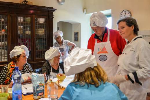 Florence Market Tour - A group of people in an Italian kitchen learning to cook with a chef.