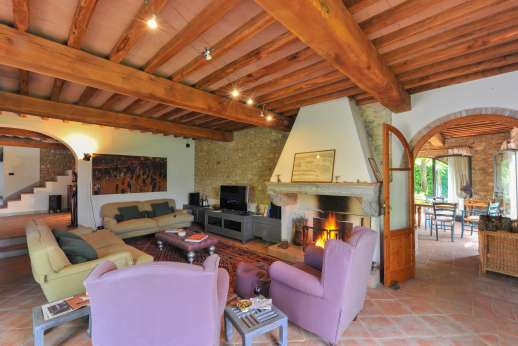 I Tre Cipressi - Ground floor sitting room with a large fireplace.