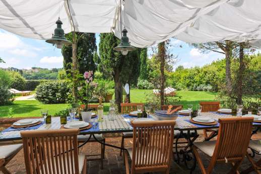 I Tre Cipressi - A paved terrace trails two sides of the villa with a large loggia furnished for alfresco meals.