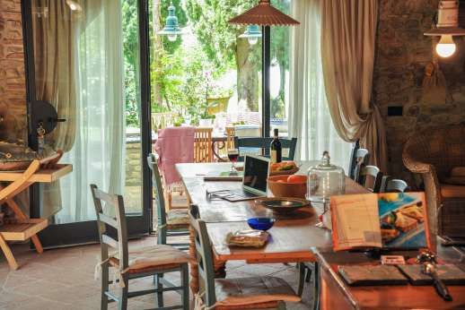 I Tre Cipressi - Dining area in the kitchen leading out into the garden