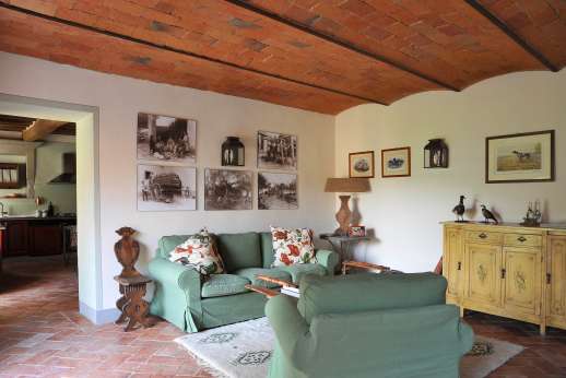 Il Borgo di Petroio - Guest house sitting area with leading into the kitchen.