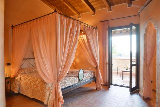 Il Chiesino - The first floor air conditioned double bedroom, with doors out to the terrace.