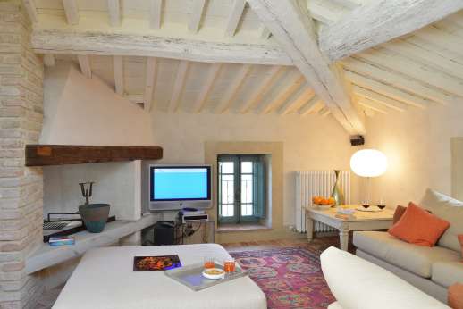 Il Cornello - Second floor sitting room with TV and fireplace.