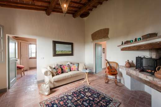 La Badiole - First floor sitting room with a non-working fireplace.