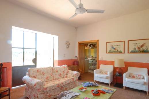 La Magione - Sitting room, French doors opening to a small loggia with a sitting area.
