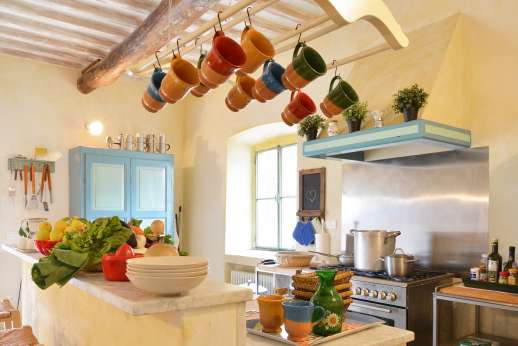 Podere Castelluccio - A kitchen with marble counters and professional stove