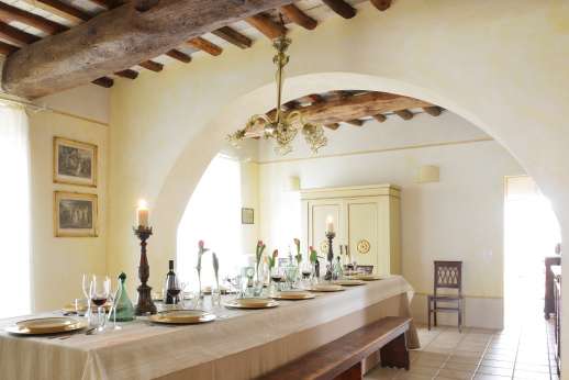 Podere Castelluccio - Elegant dining room with long table.