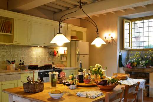 Podere Guicciardini - The well equipped kitchen leads to the loggia and courtyard.