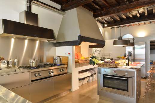 Tenuta Almabrada - Large fully-equipped kitchen leading to a spacious outside gazebo with wooden floor