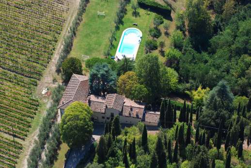 Staffed weddings at The Estate of Petroio - La Villa Di Petroio surrounded by vineyards and a view of the pool and football pitch.