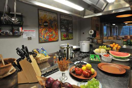 Staffed weddings at The Estate of Petroio - The professional kitchen leading through to the large dining space.