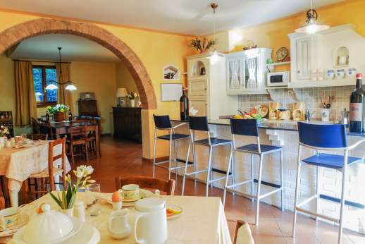 Villa D'Elsa - The kitchen with an archway leading to the open plan dining sitting room.