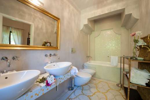 Weddings at Villa Di Masseto - En suite bathroom with two sinks.