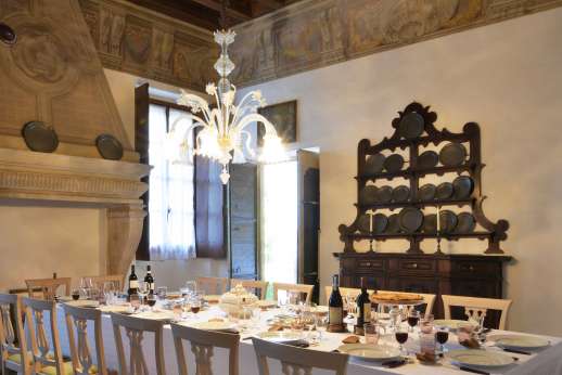 Villa Zambonina - The dining room with its elegant and characterful furniture leads out to the dining loggia.