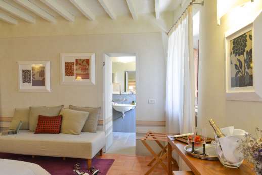 Villa Albizi - Another view of the bedroom with sofa leading through to the ensuite