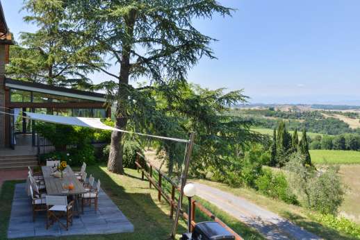 Weddings at Villa Ostignano - Kitchen leads out to shaded al fresco dining area in the garden.