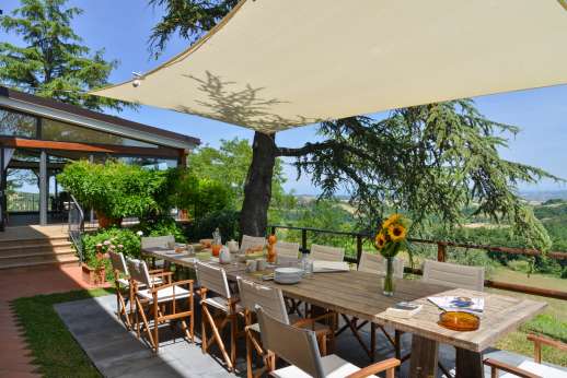 Weddings at Villa Ostignano - Shaded al fresco dining area in the garden.