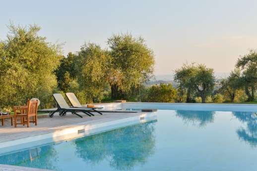 Poggio di Artemis - Relax on the sun lounges or seating areas by the pool