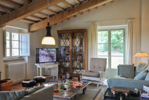 Upper ground floor sitting room with TV, two sofas, wood stove and access to the back garden
