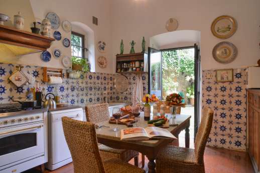 Villa San Martin - Kitchen both leading out to the courtyard with a loggia furnished for al fresco meals