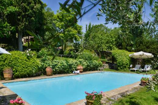 Montesassi - Down by the private swimming pool, 7 x 15 meters/22 x 48 feet, you have to shaded pergola with a dining table