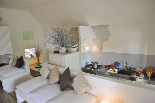 L'Agrumeto dell'Isola - High tech kitchen with door leading out to the travertino terrace with dining table.