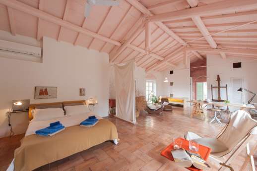 L'Agrumeto dell'Isola - The first floor bedroom is accessed by an external staircase. With high ceilings stretching the length of the villa, this is a fantastic place to spend your time.