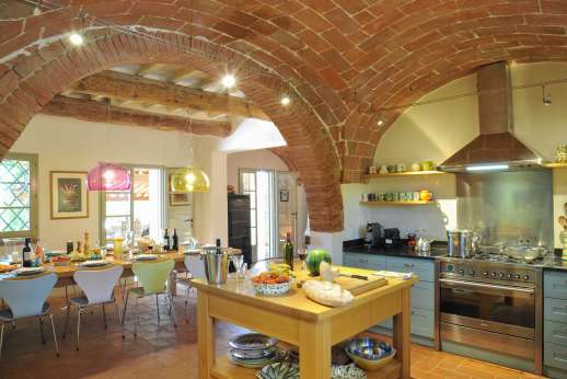 La Badiole - Kitchen leading into the dining room leading to the dining loggia