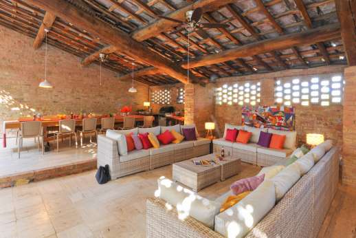 Ocrata Bianca - The core of Ocrata Bianca is the large loggia with beamed ceiling across the courtyard furnished with  modern settees and coffee tables