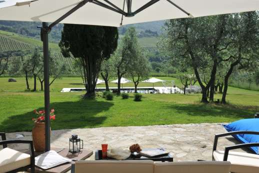 Poggetto Rosato - View down to the pool from the shaded seating area by the villa