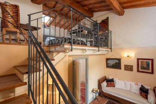 Podere Brogi - Air-conditioned double bedroom suite set on a mezzanine with a private balcony and an ensuite bathroom with shower.