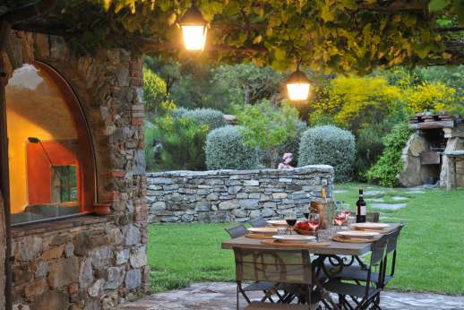 Casetta Termine - Dining pergola in the evening with stone Barbeque in the garden