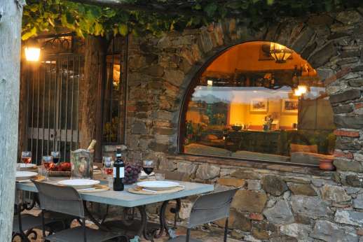 Casetta Termine - kitchen, opening to a loggia and a terrace with sitting and dining areas