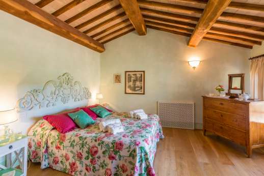 Podere Celli - One of two air conditioned double bedrooms [US California King size] sharing a bathroom with shower.