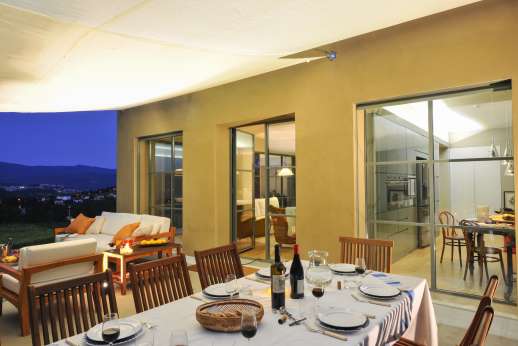 Il Soldano - The shaded paved terrace is furnished with a dining table and a very comfortable outdoor seating area with settees and armchairs