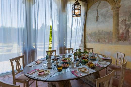 Villa Zambonina - Dining area located on the main façade overlooking over the Italian gardens and leading through to the dining room.