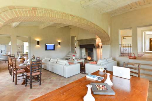 Il Cornello - Down 4 steps to a large sitting/dining room with a large fireplace, a flat screen TV and three French doors leading out to the garden