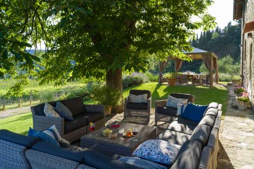 The Estate Of Petroio - Open air living area with comfortable sofa shaded by a large chestnut tree at the main house of Il Borgo di Petroio