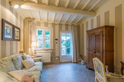 Fontegaia - The entrance to the ground floor of the house is from the garden into a small sitting room with desk and sofa