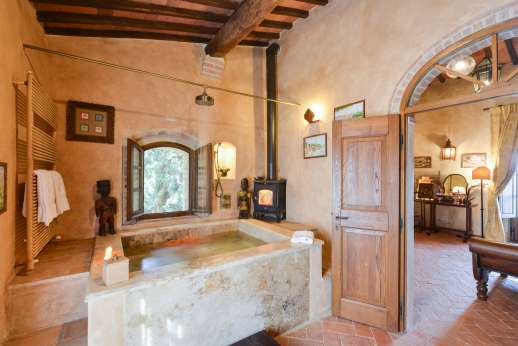 Belsguardo -  The en-suite bathroom features a unique large travertine stone bath with jetted tub heated by wood-burning stove