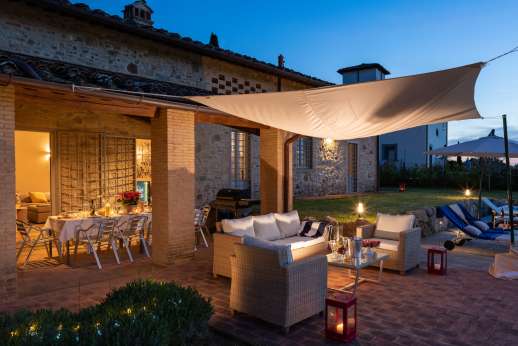 Maggiano Piccolo - Glass doors open out from the kitchen onto a loggia furnished with a convivial dining table, creating the perfect outdoor dining area
